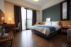 Postel nebo postele na pokoji v ubytování Chuying Sunrise B&B
