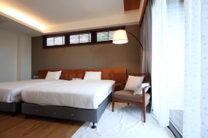 Postel nebo postele na pokoji v ubytování Chuying Sunrise B&B