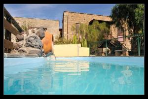 a large swimming pool with a fountain in a building at Casa Rural La Venta in Granadilla de Abona