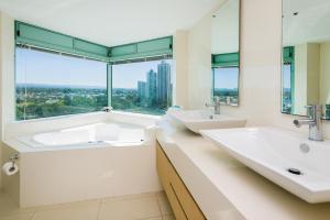 a bathroom with two sinks and a large window at The Waterford on Main Beach in Gold Coast