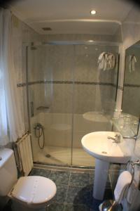 a bathroom with a shower and a toilet and a sink at Pensión Bilbao in Bilbao