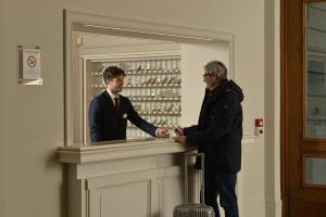 two men shaking hands in front of a mirror at Centro Paolo VI in Brescia +60 photos