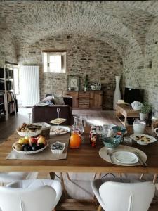 a living room with a table with food on it at B&B Il Pozzo e la Macina in Bardi