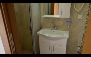 a bathroom with a sink and a shower at GÜVEN HOTEL in Canakkale +37 photos
