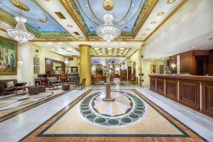 a lobby with a reception desk and a lobby with a building at Imperial Palace Classical Hotel Thessaloniki in Thessaloniki