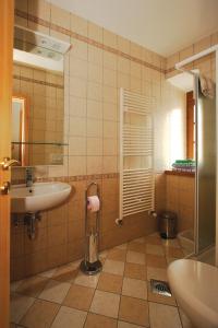 a bathroom with a sink and a toilet and a mirror at Apartments Janks in Vremski Britof