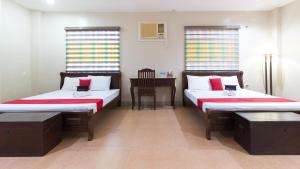 A bed or beds in a room at RedDoorz at Teofila Lodge