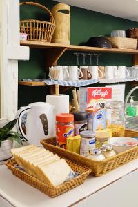 a counter with bread and other food items on it at Barn Laos Hostel in Vientiane