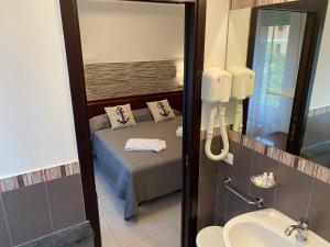 a bathroom with a bed and a sink and a mirror at L'ancora di Monterosso - Cinque Terre in Monterosso al Mare +39 photos