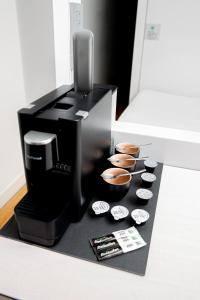 a coffee maker sitting on a counter with bowls at Qbic Hotel WTC Amsterdam in Amsterdam