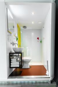 a bathroom with a white toilet and a sink at Qbic Amsterdam WTC in Amsterdam