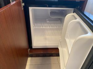an empty refrigerator with its door open in a room at L'ancora di Monterosso - Cinque Terre in Monterosso al Mare