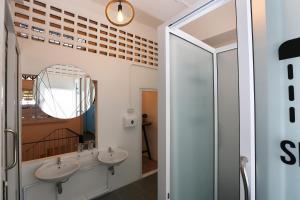 a bathroom with two sinks and a mirror at Hub Hostel Hatyai in Hat Yai