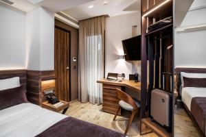 Habitación de hotel con cama y escritorio en Imperial Plus Urban Smart Hotel Thessaloniki en Tesalónica