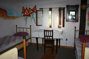 a bedroom with a table and a chair and a desk at Guest House Sunčano Selo in Jagnjedovec +38 photos