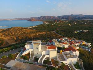 an aerial view of a house with a lake at Castri Village Hotel in Palekastron