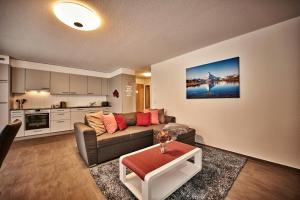 sala de estar con sofá y mesa en Apartment Breithorn - Charming home - free parking & Wifi, en Lauterbrunnen