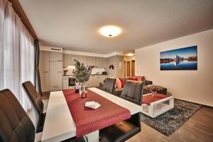 a living room and dining room with a table and chairs at Apartment Breithorn - Charming home - free parking & Wifi in Lauterbrunnen