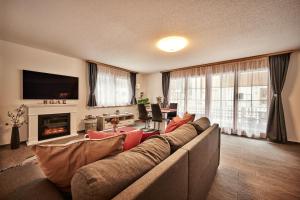 a living room with a couch and a fireplace at Apartment Breithorn - Charming home - free parking & Wifi in Lauterbrunnen