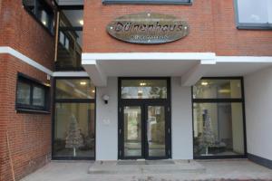 a store with a sign on the front of a brick building at Dünenhaus Wohnung 7 in Lübeck