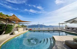 a large swimming pool with a balcony overlooking the ocean at Le Petit Nice - Passedat in Marseille