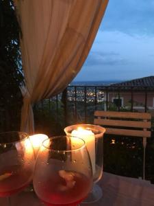 dwie szklanki wina ustawione na stole ze świecami w obiekcie Residenza Buggiano Antica B&B - Charme Apartment in Tuscany w mieście Borgo a Buggiano +37 zdjęć