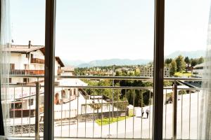 a view of a city from a window at Hillsite Smart Hotel Flims in Flims