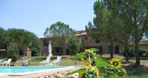 a villa with a swimming pool and a house at Casetta Francini in Civitella Marittima