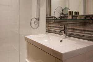 a white bathroom with a sink and a mirror at HomefromHolme Alban House in St. Albans
