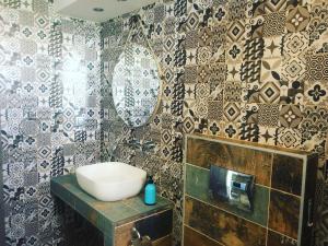 a bathroom with a sink and a mirror on a wall at Zinozis Beach Apartments in Vourvourou