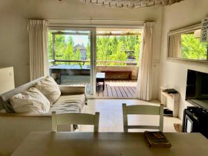a living room with a couch and a table at Palmas de la Pedrera maravillosa casa in Rocha