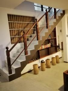 a staircase in a living room with a book shelf at Sithila Villa in Mount Lavinia