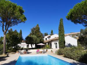a villa with a swimming pool and a house at Villa in Campagnan with Pool and Vineyard Views in Campagnan