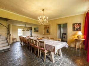 uma sala de jantar com uma mesa longa e cadeiras em Beautiful farmhouse in Beernem with big garden em Beernem