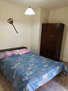 a bedroom with a bed and a dresser in it at Casa duplex Frente AL Mar familiar Depto A in Mar del Plata