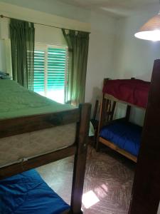 a bedroom with two bunk beds and a window at Casa duplex Frente AL Mar familiar Depto A in Mar del Plata