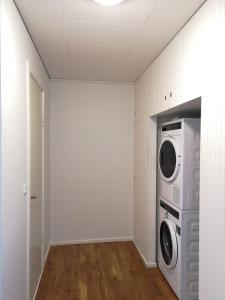 a laundry room with a washer and dryer in it at Tórshavn Apartment - Great View in Tórshavn