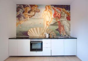 a kitchen with a painting on the wall at DAREBELL Apartment Gratkorn Top 2 in Gratkorn