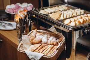 a buffet with bread and pastries on a table at Girski Hotel&Spa in Bukovel