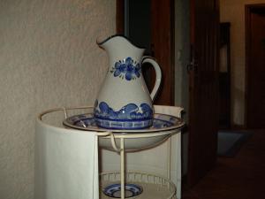 a blue and white vase sitting on top of a microwave at Quinta De Cabrum in Alvoco da Serra