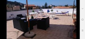 a patio with tables and chairs on a roof at La Piazza in Sant'Agnello