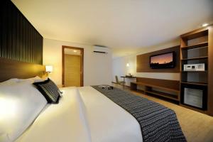 Ένα ή περισσότερα κρεβάτια σε δωμάτιο στο Radisson Hotel Belém