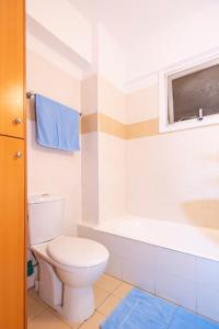 a bathroom with a toilet and a bath tub at Olympia flat 201 in Larnaca