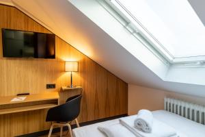 Ένα ή περισσότερα κρεβάτια σε δωμάτιο στο mk hotel frankfurt