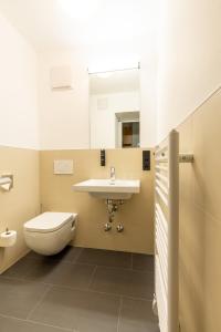 a bathroom with a sink and a toilet at mk hotel frankfurt in Frankfurt