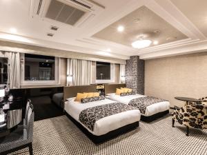 Postelja oz. postelje v sobi nastanitve APA Hotel & Resort Midosuji Hommachi Eki Tower