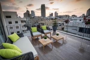 a rooftop balcony with a view of a city at Emilia TLV in Tel Aviv