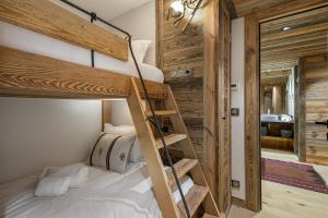 a bedroom with a bunk bed and a staircase in a room at Appartement Ourson - LES CHALETS COVAREL in Val dʼIsère