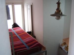 una camera con un letto, una lampada e una finestra di la terrazza a Vernazza
