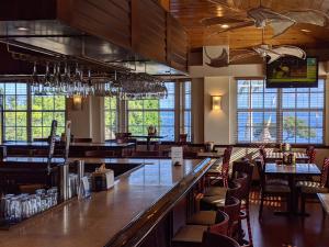 a bar in a restaurant with tables and chairs at Ocean Oasis at Ocean Pointe in Tavernier